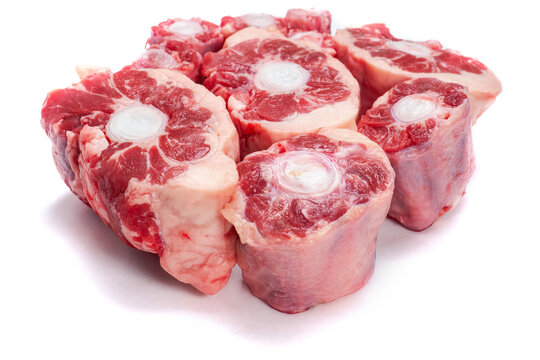 Pile of fresh raw ox tail portion on white background. Meat industry concept