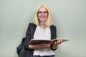 Portrait of happy student girl teenager 16 years old in glasses with backpack