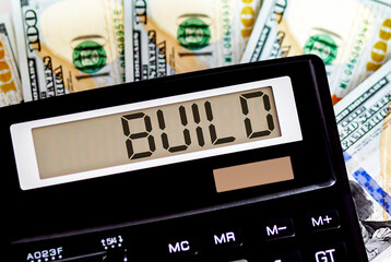Calculator with text BUILD on the dollars. Business, finance conceptual.