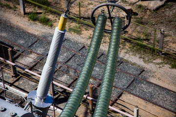 Close-up of glass isolators (insulators) of electric transformer station on powerhouse (Generation...