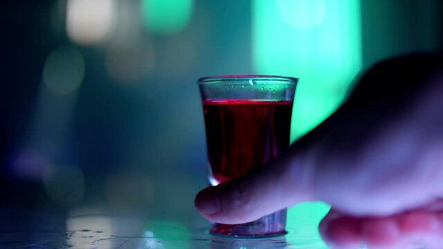 Vodka shots on the bar counter in a nightclub party.
