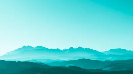 Fotobehang Green surreal mountains against the backdrop of a turquoise sky, fantastic fairytale mountain landscape © Bogdan
