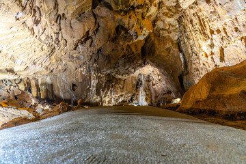 Fototapeta na wymiar Illuminated picturesque karst rock formations in Balcarka Cave, Moravian Karst, Czech: Moravsky Kras, Czech Republic