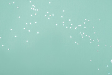 White stars on turquoise backdrop. Festive concept. Flat lay style.