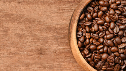 Close up of coffee beans in wooden bowl for background
