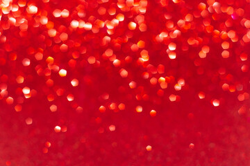 Festive new year background in red with bright bokeh lights .Gradient of lights from top to bottom. Space for notes and captions.