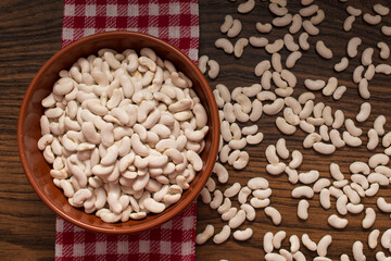 organic white bean legume in bowl and red napkin