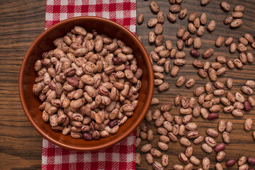 Bean paints ecological legume in bowl and red napkin