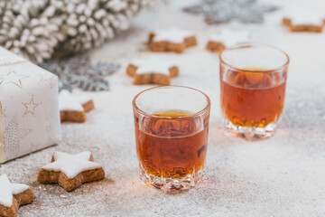 Whiskey, brandy or liquor, cookies and chrastmas decorations on white background