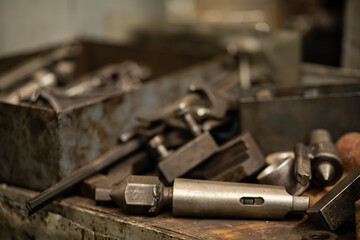 metal parts and tools in the factory, worker's table, locksmith tools in the workshop