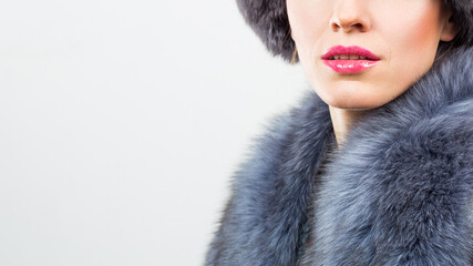 Winter fashion style. Beautiful woman in fur and jewelry. Portrait of young sexy model with beauty makeup