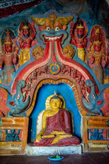 Fototapeta na wymiar Ancient colorful statue of the Buddha in Ravana Temple near Ella town on the island of Sri Lanka