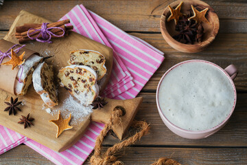 Homemade traditional christmas dessert stollen with dried berries, nuts and powdered sugar on top
