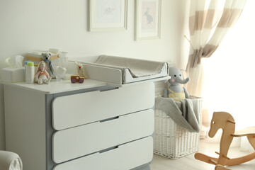Modern changing table in baby room interior