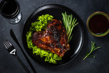 Baked turkey thigh with sauce and herbs.