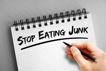 Text note - Stop Eating Junk, health concept on notepad