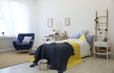 Modern teenager's room interior with bed and armchair