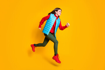 Full length profile side photo of cheerful girl jump enjoy season discount run fast wear blue green sweater boots isolated over bright shine color background
