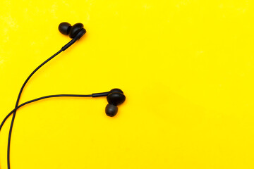 black Earphones on yellow background. Music is my life concept