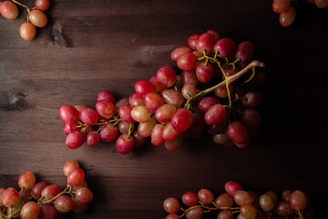bunch of red grapes on a wooden table