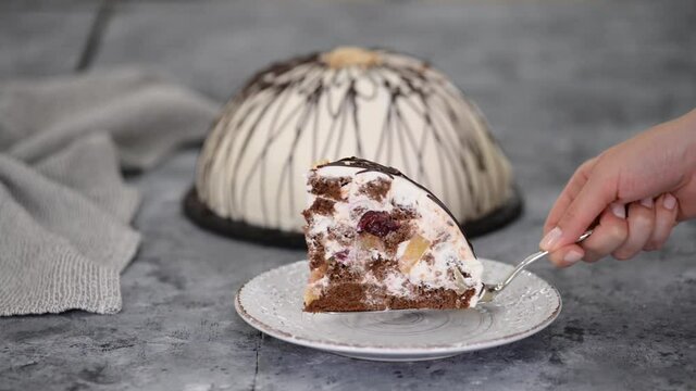 Piece of Pancho cake with pineapple and sour cream topped with chocolate and nuts.