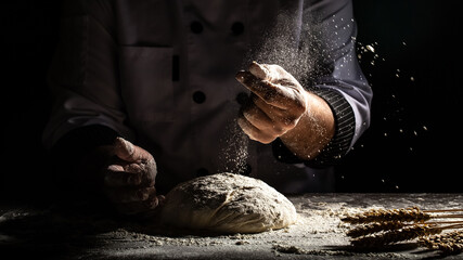 Photo of flour and men hands with flour splash. Cooking bread. Kneading the Dough. Isolated on dark background. Empty space for text