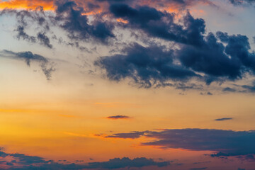orange sunset sky with lighted clouds