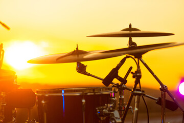 Close up photo of set drums on rooftop at sunset time