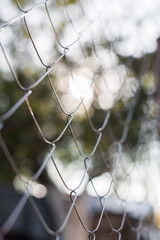 Metal grid on a background of beautiful bokeh sunset