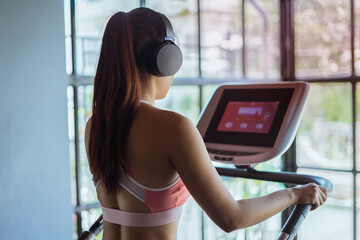 Sporty young woman doing fitness exercise at gym. Workout and healthy lifestyle concept.