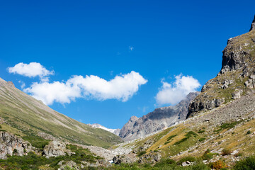 Mountain landscape view in Kyrgyzstan. Green grass in mountain valley view. Mountain panorama.