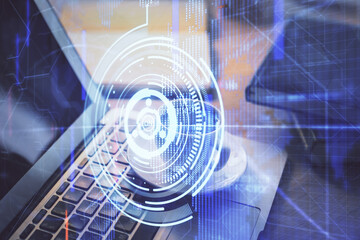 Double exposure of desktop computer and technology theme hologram. Concept of software development.