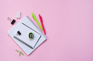 School supplies on a paper pink background. Back to school.