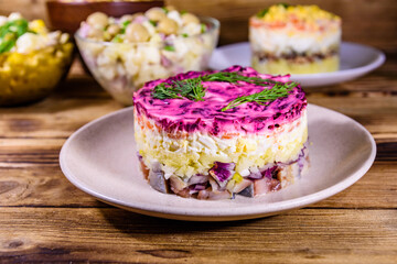 Set of festive mayonnaise salads on wooden table