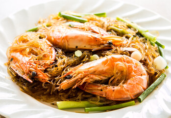 Baked prawns with noodles in plate , Thai famous food 