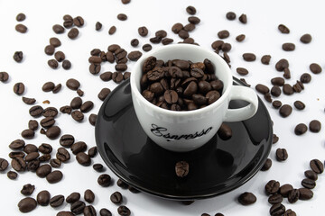 A cup of espresso filled with coffee beans