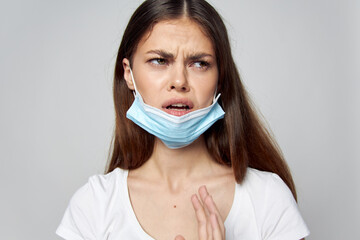 Woman in medical mask on face emotions look aside displeasure 