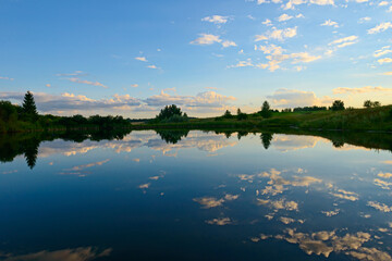 reflection of clouds in the lake at sunset of the day