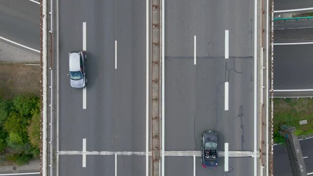 Highway interchange top-down drone aerial view with cars moving fast in the complex intersection. Commuting in large cities, interstate traffic, 4k video footage
