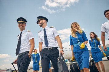 Joyful aircrew walking down the airfield after the flight © Svitlana