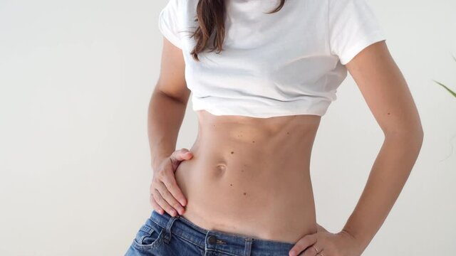 Fit sporty woman with abs and c-section scar. Postpartum recovery