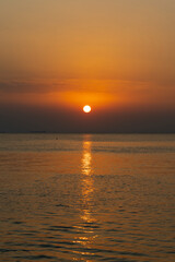 Glowing orange Sunset over private beach area in the Eastern Province of Saudi Arabia 