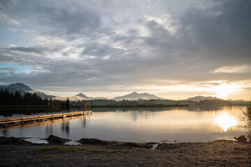 Sunset at a lake with a bridge in it