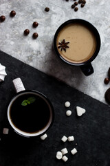 Black and white circles stand on a black and white background. Two cups, one with coffee, the other with tea on a black and white background