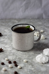 a white mug stands on a white background surrounded by sweets, candies and cookies