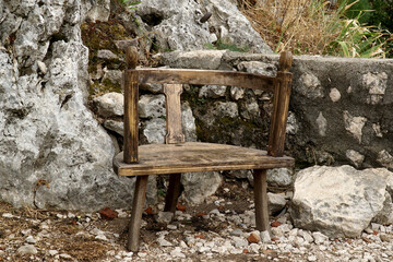     Old wooden chair on a mountain path as a place to relax.