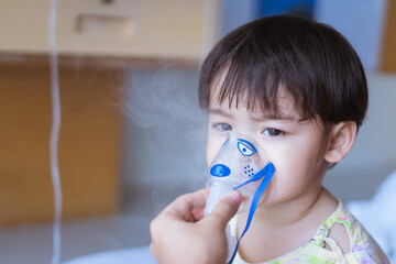 Little Asian boy under anesthesia with an oxygen mask in hospital.