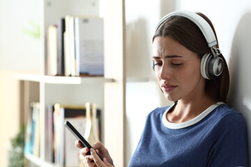 Sad teen complaining listening to music