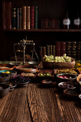 Natural medicine background. Assorted dry herbs in bowls and brass mortar on rustic wooden table.