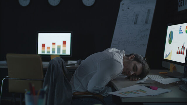 Fatigue business analyst sleeping on table front computer screen in night office - Powered by Adobe
